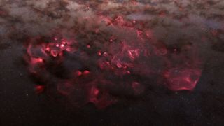 Clouds of pink and red swirl like smoke amidst the darkness of space