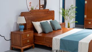 A wooden bedframe and bedside table