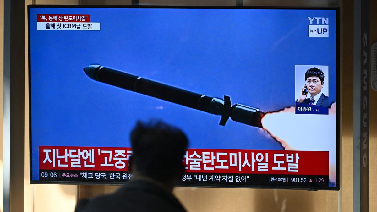 a screen showing a missile with a blurry image of a person standing in front