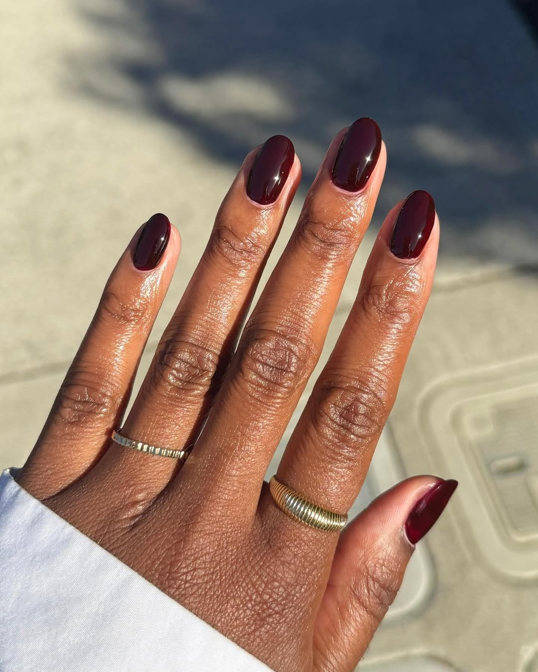a person wearing a blood red manicure