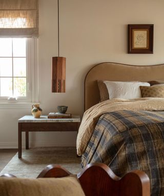 Warm neutral bedroom with velvet headboard