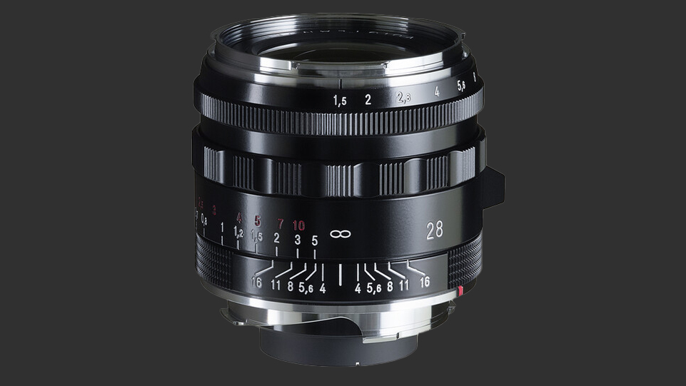 The Voigtlander Nokton 28mm f/1.5 Vintage Aspherical Type II lens in front of a black background