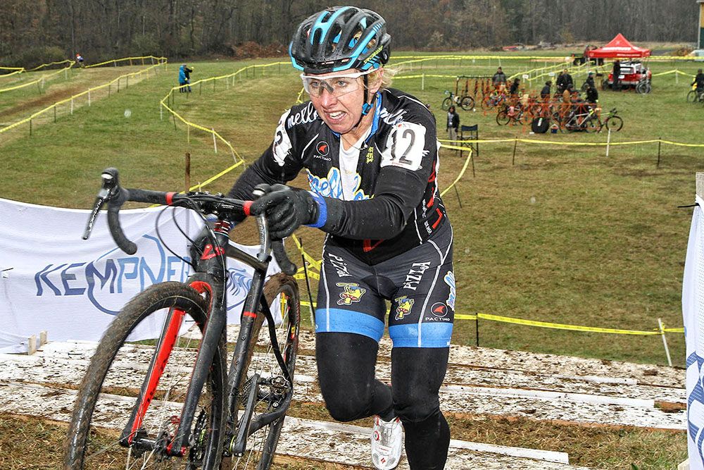 Laura Van Gilder pushes her bike up the muddy steps
