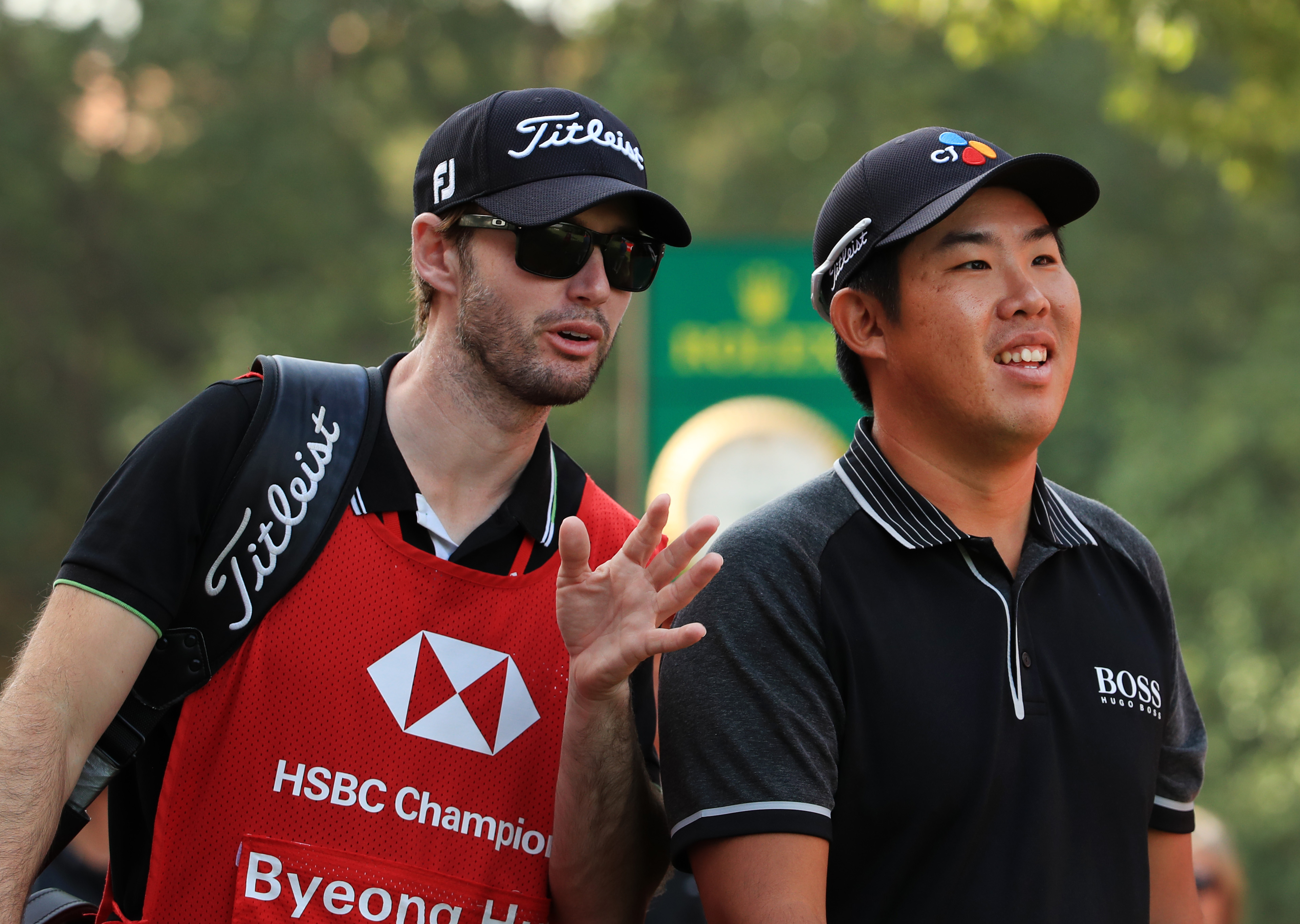 Byeong Hun An and his then-caddie Daniel Parratt (left) talk during the 2019 WGC HSBC Champions