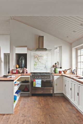 small white kitchen with vaulted ceiling and tongue-and-groove panelling
