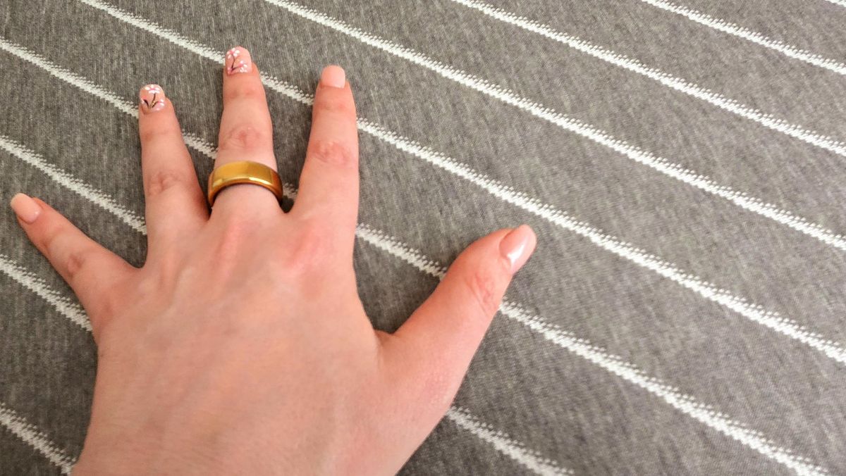 Tester's manicured hand on the cover of the Siena Premier Hybrid Mattress