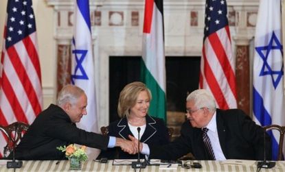 Israeli Prime Minister Benjamin Netanyahu shakes hands with Palestinian Authority President Mahmoud Abbas during the first day of negotiations about a Middle East peace plan.