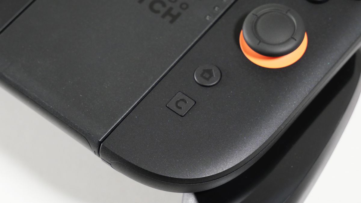 Nintendo Switch 2 Joy-Con 2 Grip laying on a white desk, highlighting its C button.
