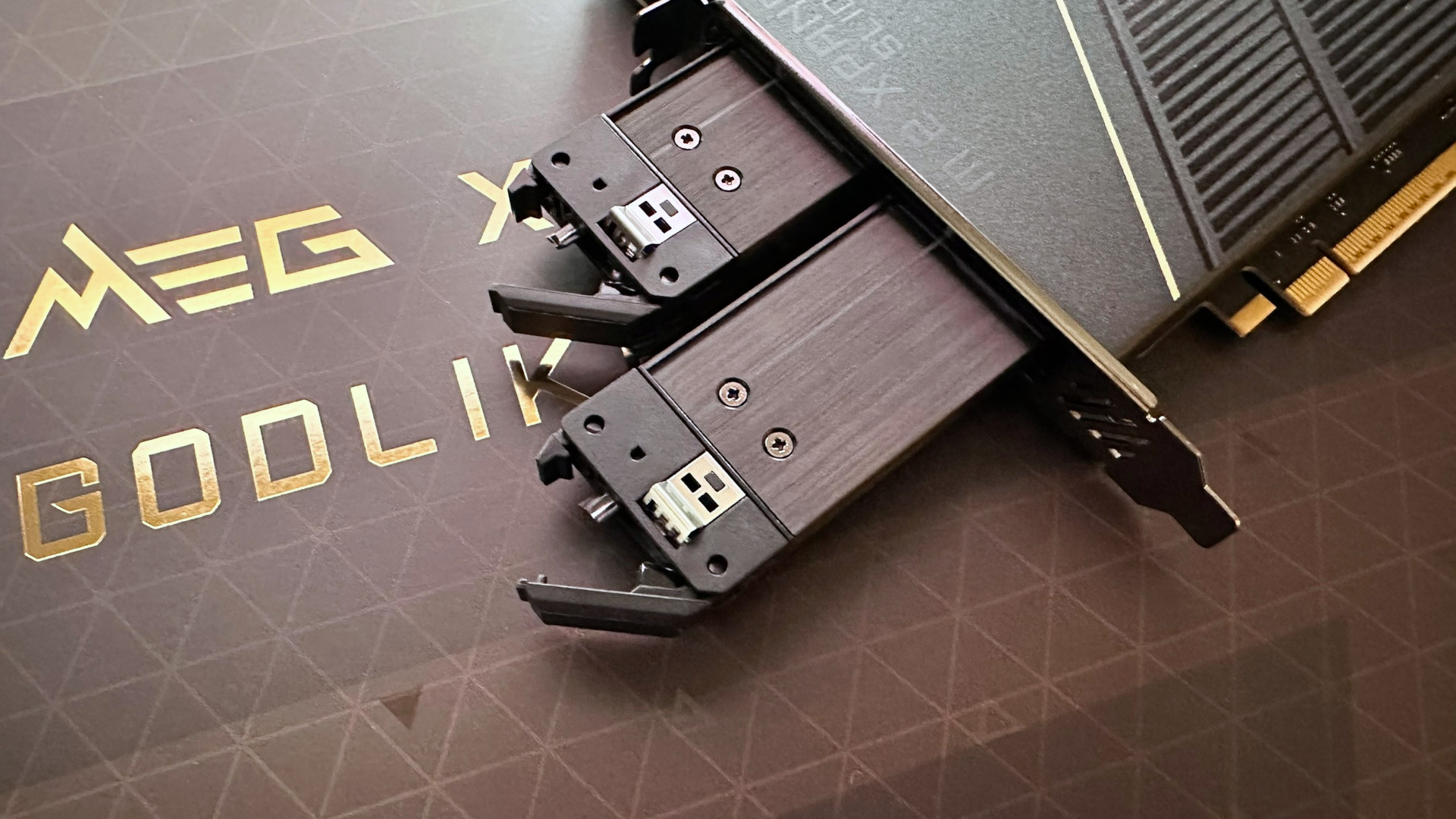 A photo showing two SSD holds ejected from an MSI M.2 Xpander-Z Slider adapter card