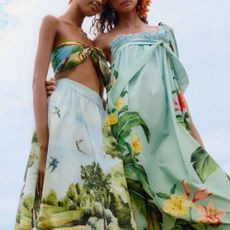 Two female models wearing dresses from Farm Rio. 