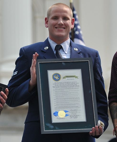 Spencer Stone holds an award.