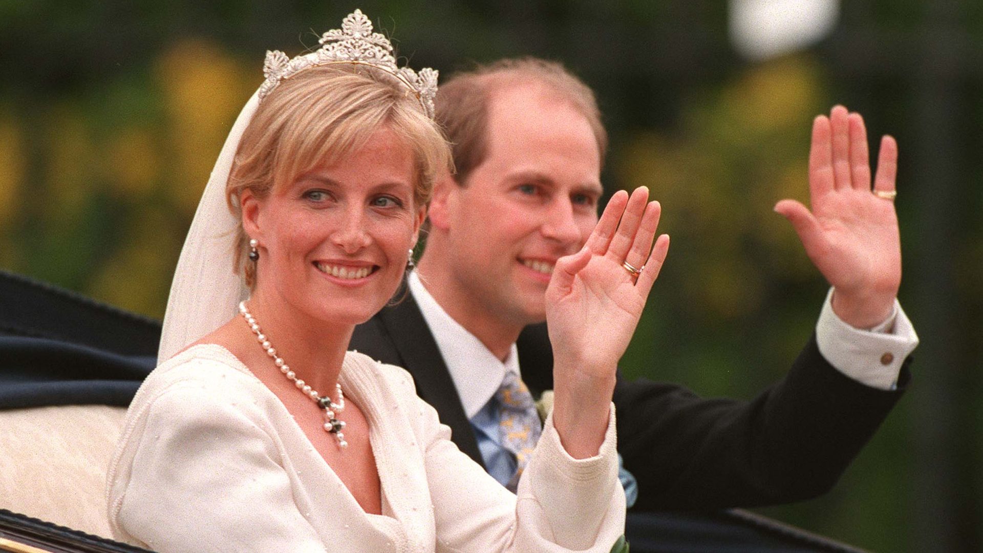 Duchess Sophie and Edward on their wedding day waving in a carriage