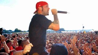 Limp Bizkit’s Fred Durst performing in the crowd at the 2001 Reading Festival