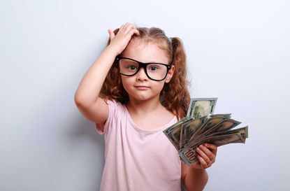 photo illustration of confused child holding money