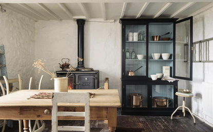 a country kitchen idea with authentic original features, beams and a wood burning stove in a cottageby devol