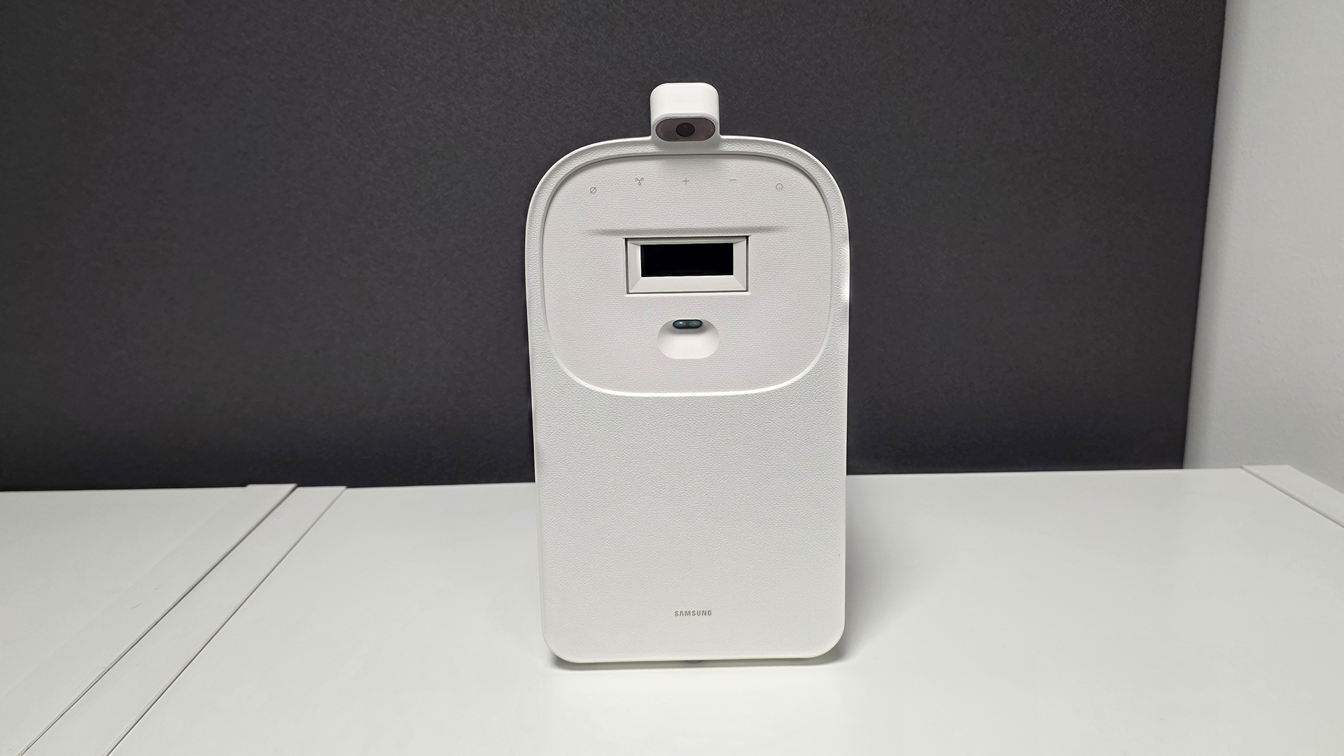 Samsung The Premiere 5 ultra short throw projector with lens in side-on position, on white surface