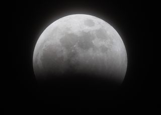 close up view of half illuminated moon.