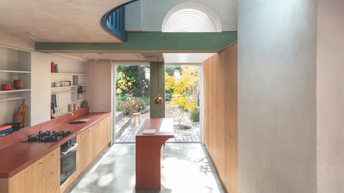 long modern kitchen with open ceiling up to landing