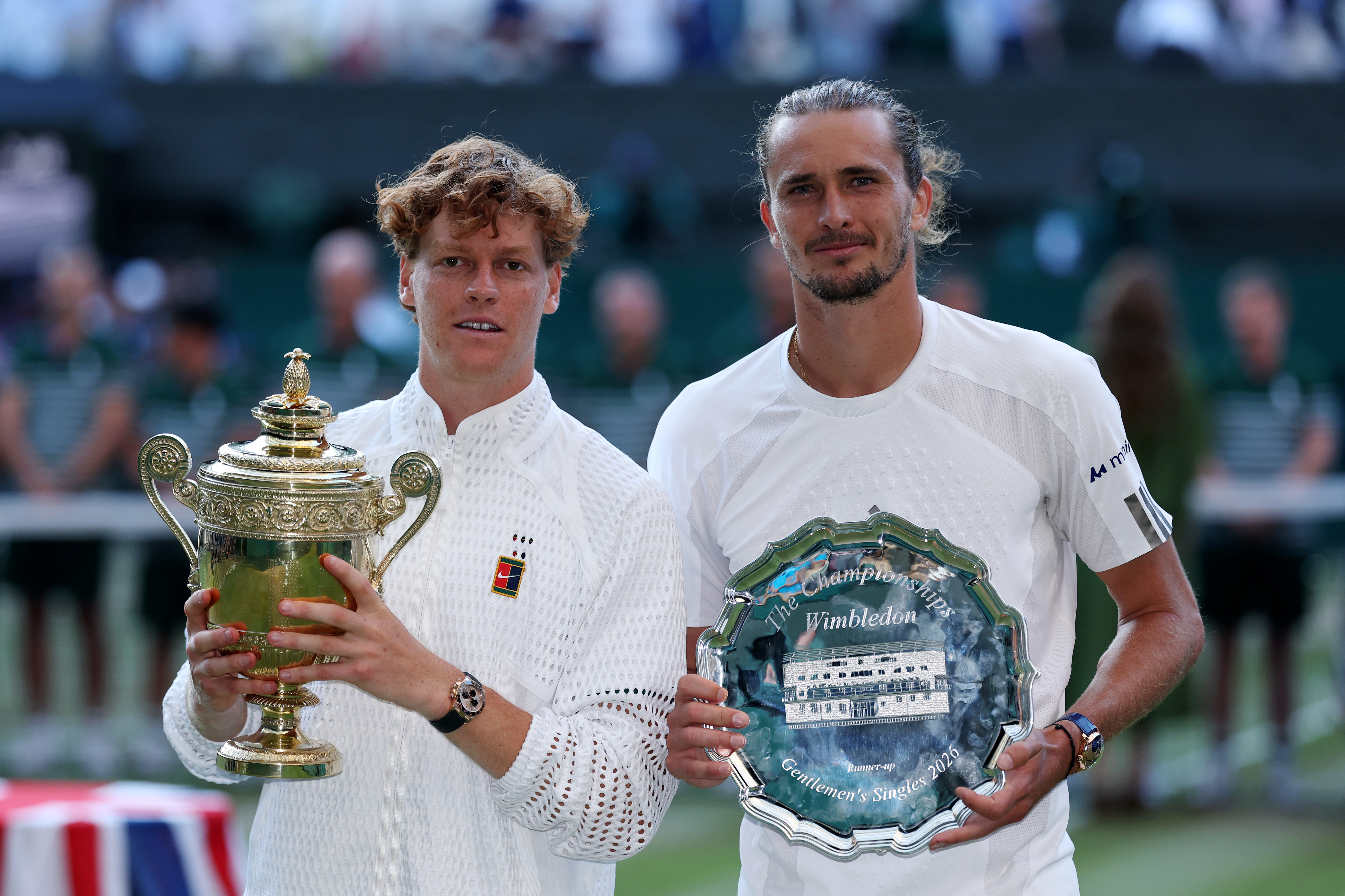 Jannik Sinner and Alexander Zverev stand with trophy and plate respectively after the Wimbledon Men's Singles Championship 2026