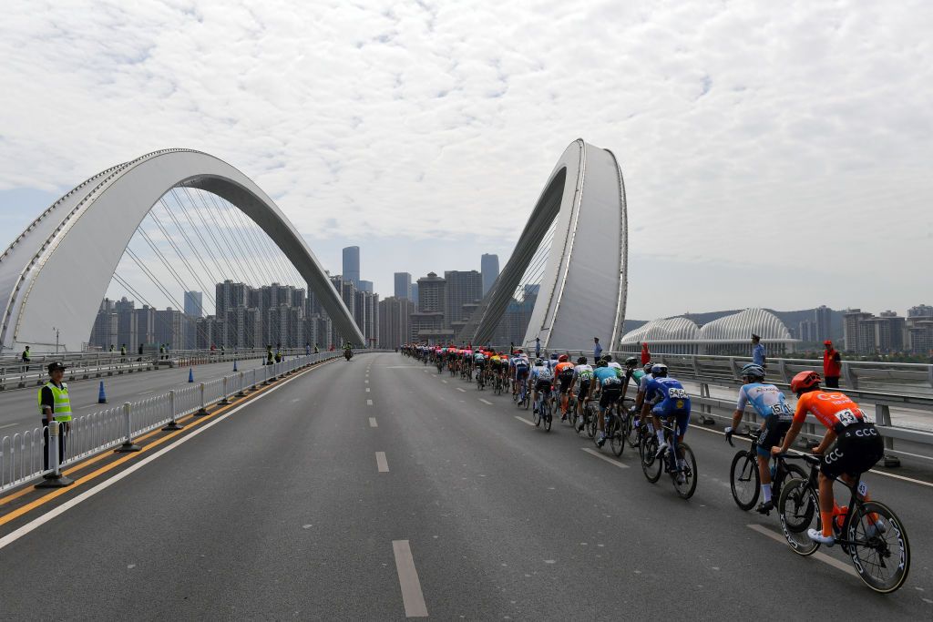 The peloton head over a bridge in the final kilometre of stage 3