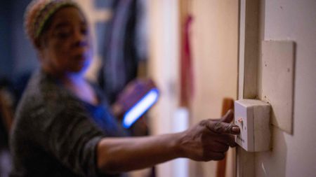 A woman switching off a light