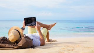 Man with tablet on the beach