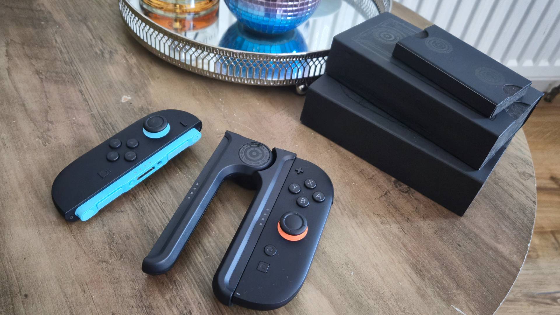 Photo of the dbrand Joy-Lock controller holder sitting on a coffee table.