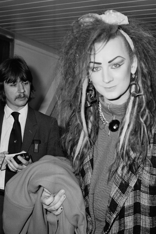 1980s Fashion: Boy George wearing his iconic androgenous look of makeup and dreadlocks
