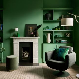 Green painted living room, fireplace and mantelpiece, armchair