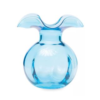 A circular light blue glass vase with two curved edges at the top