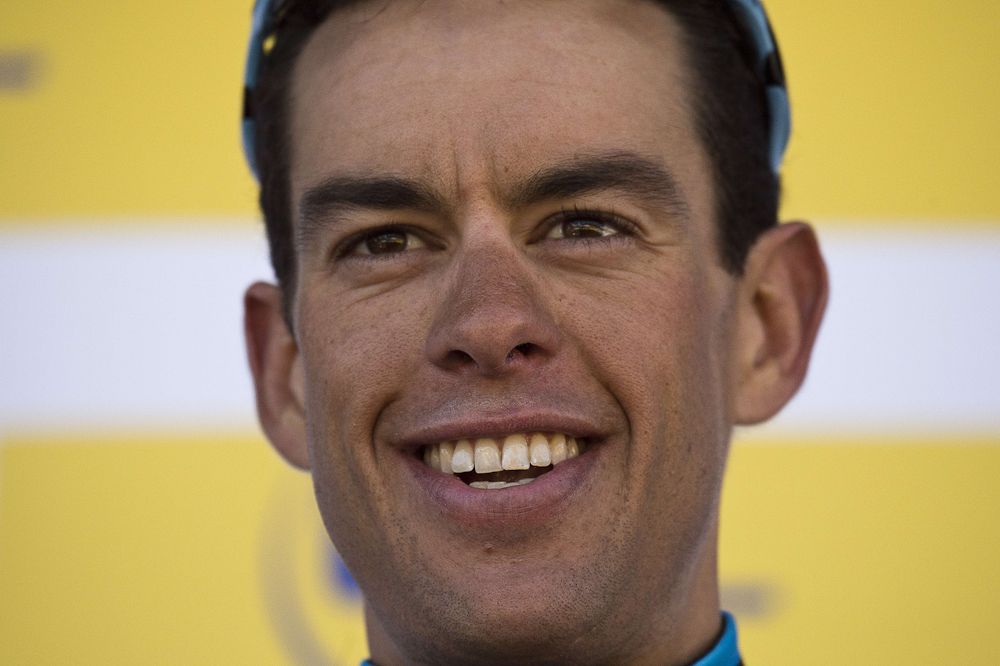 Stage winner Australia's Richie Porte celebrates on the podium after winning the fourth stage.