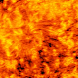 The large sunspot, imaged at a radio wavelength of 3 mm. This image shows a layer of the chromosphere higher up than the last, obscuring the sunspot's distinct shape.