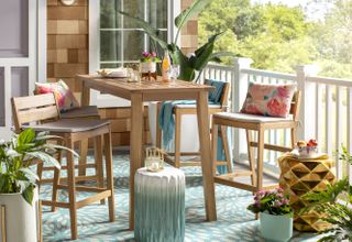 outdoor dining space with cushions and rug