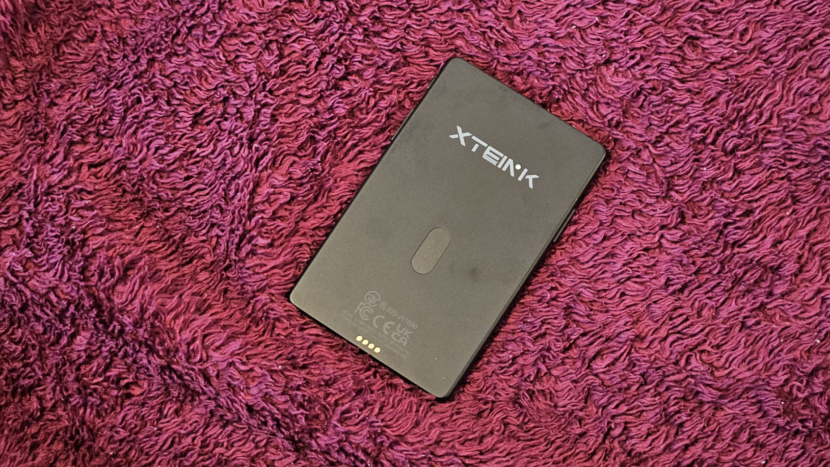 The Xteink X4 Pro against a purple background