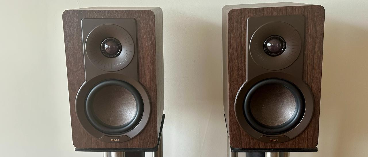 A pair of Dali Kupid bookshelf speakers, mounted on two stands.