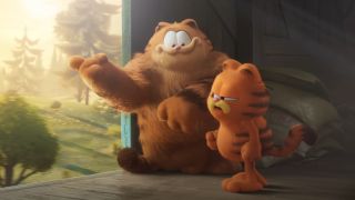 Vic and Garfield standing on a train looking out the door in The Garfield Movie