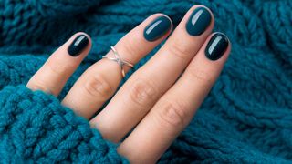 Hands with dark blue nail polish
