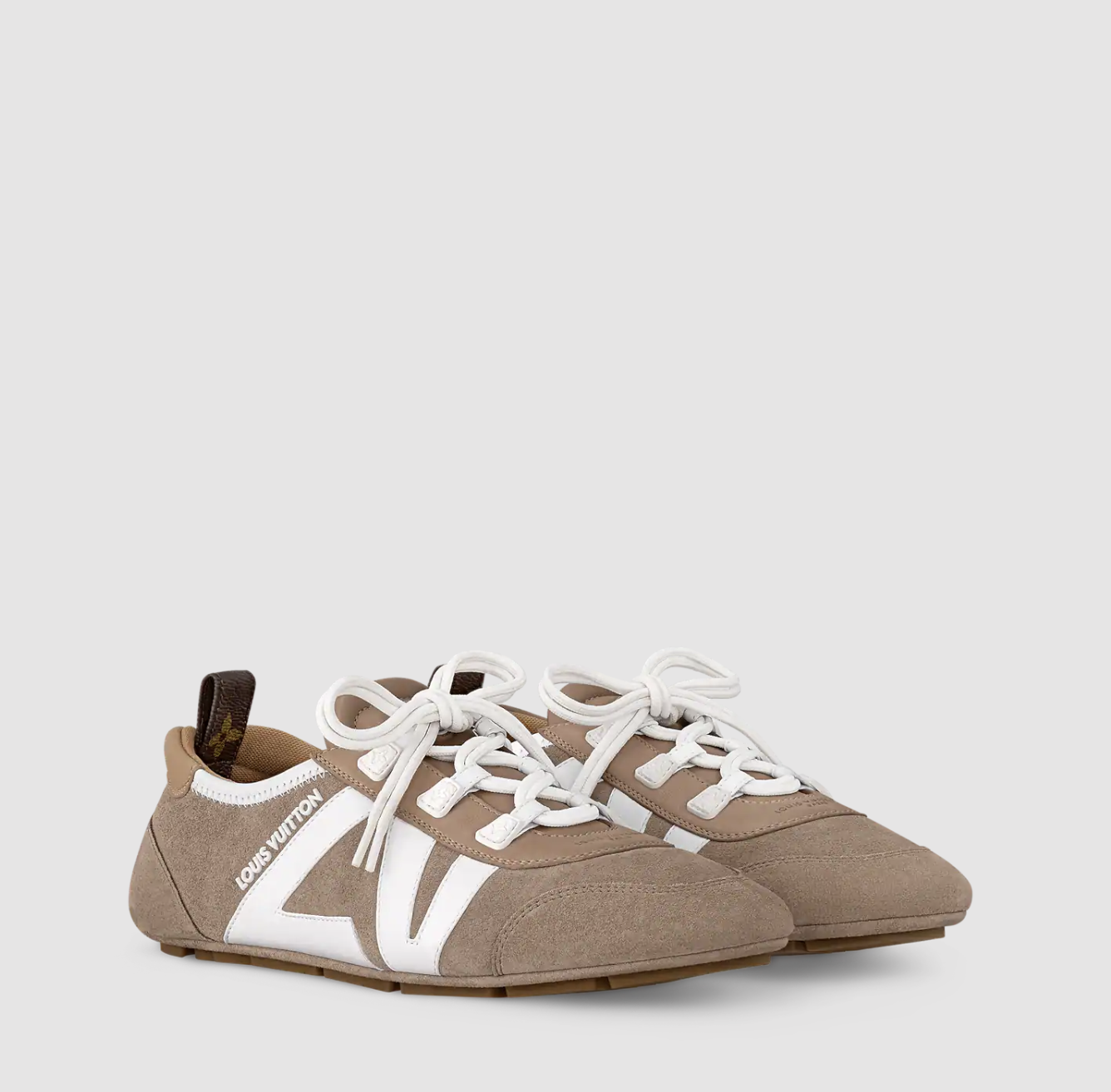 a pair of louis vuitton sneakerinas in front of a plain backdrop