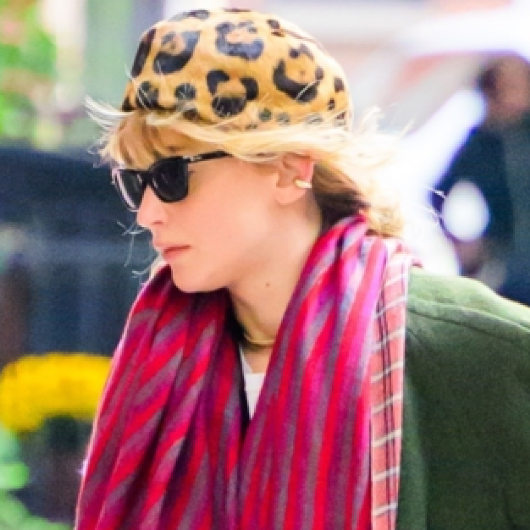 Jennifer Lawrence wears a leopard print pillbox hat with a coat