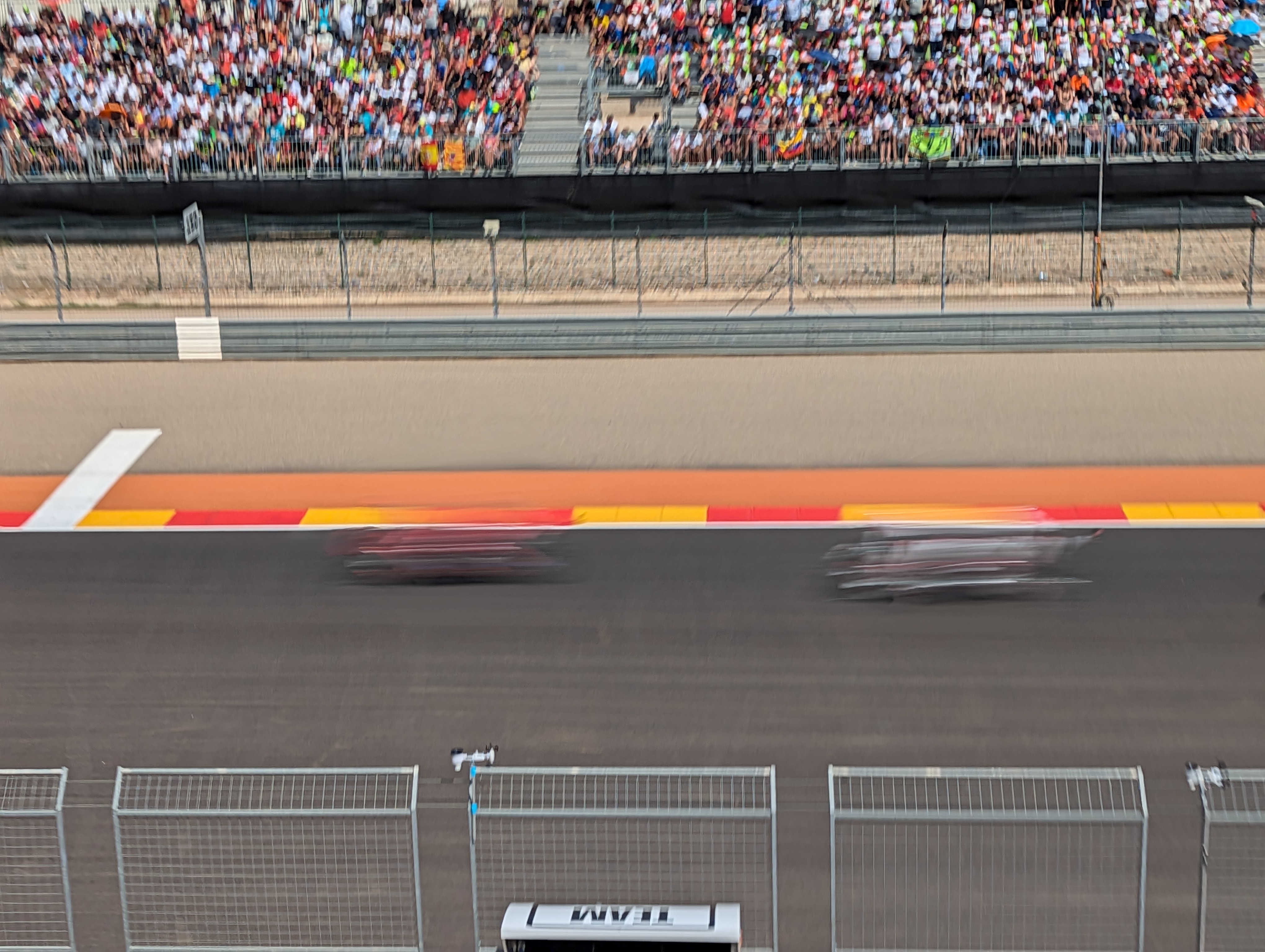 MotoGP riders at full speed on racetrack with action panning photography technique accentuating movement