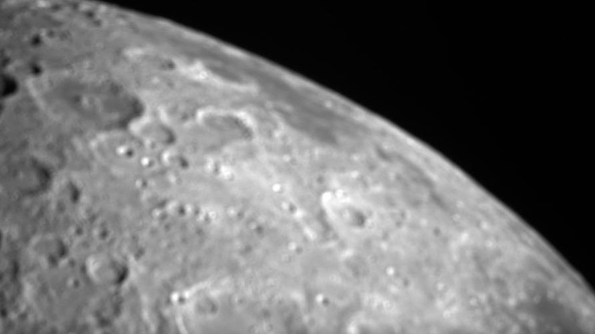 A close-up shot of the moon&#039;s north polar region, with many craters, against the blackness of space.