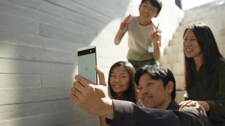 Family taking a selfie with the Sage Google Pixel 6a