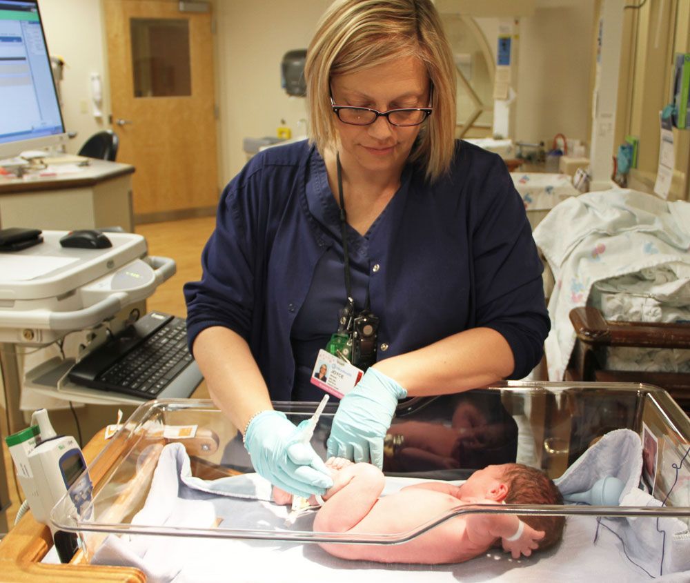 Nurse administers vitamin K shot