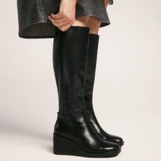 A model wearing a pair of platform, leather boots from Vagabond.