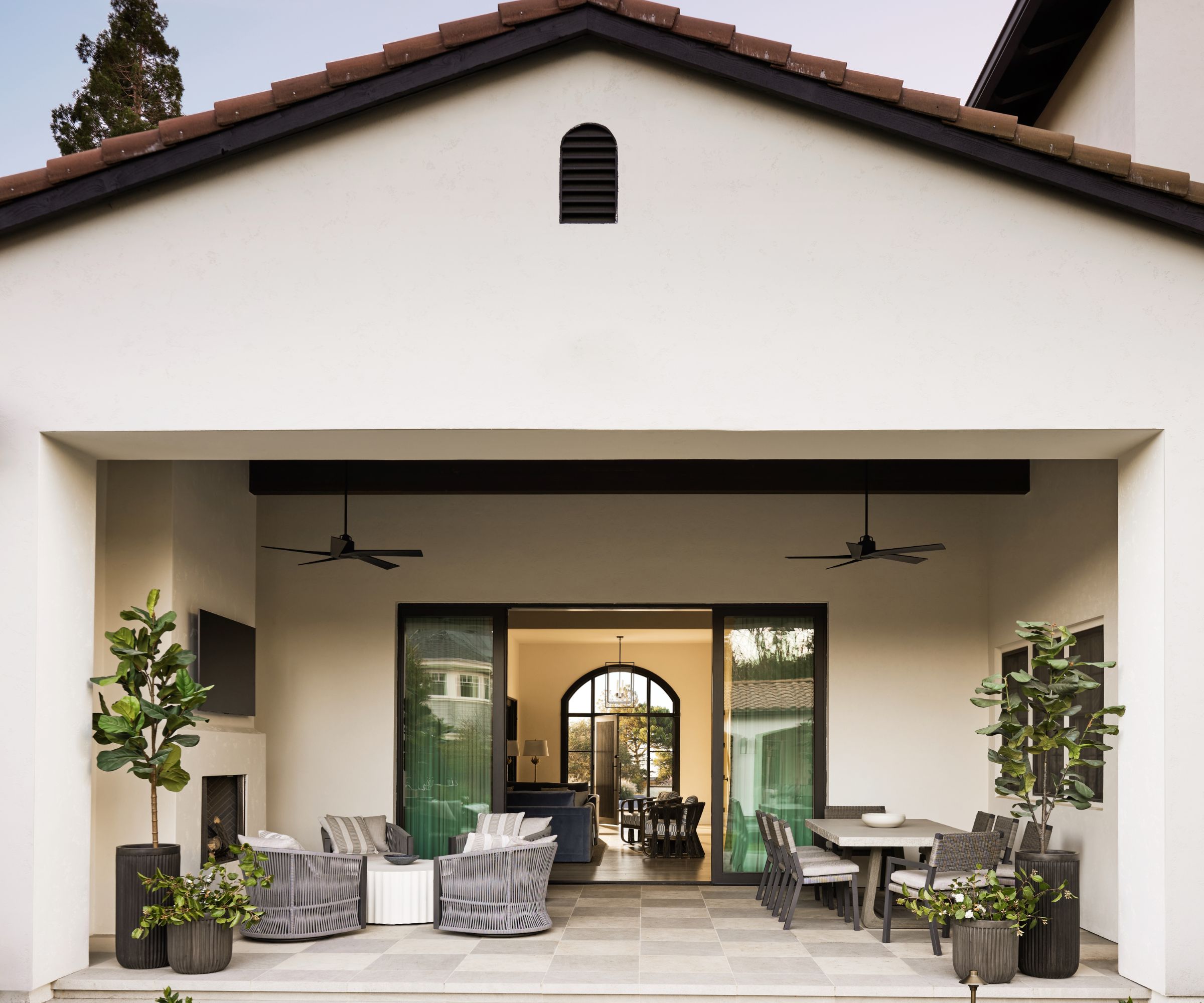 whitewashed loggia with seating and dining space near pool