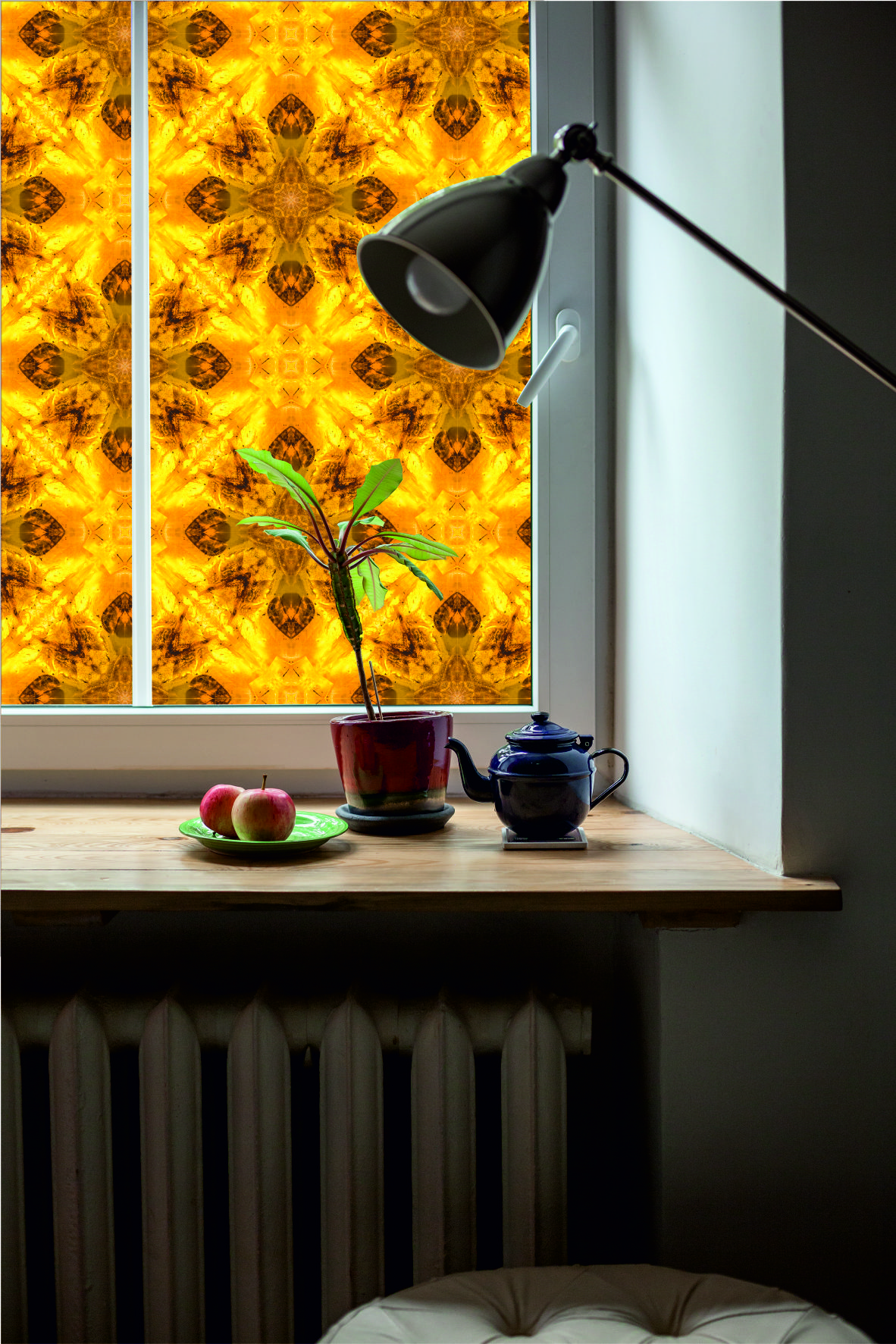 Amber window film with floral pattern, with wooden table window sill and lamp