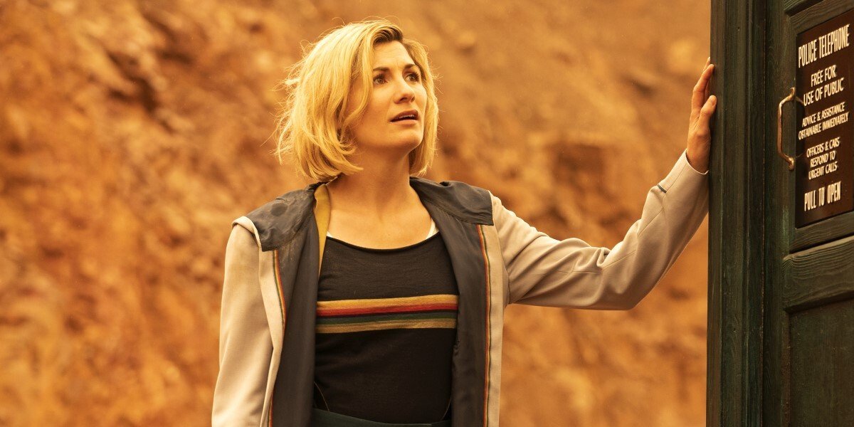 Jodie Whittaker puts her hand on the side of the TARDIS in Doctor Who.