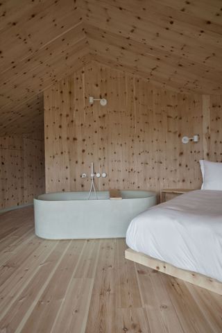 Wooden bedroom and bathtub