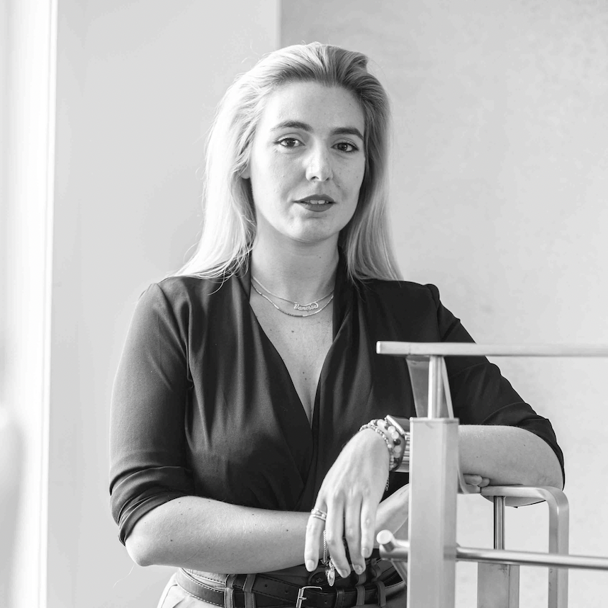 A grayscale photo of a woman with blonde hair wearing business attire