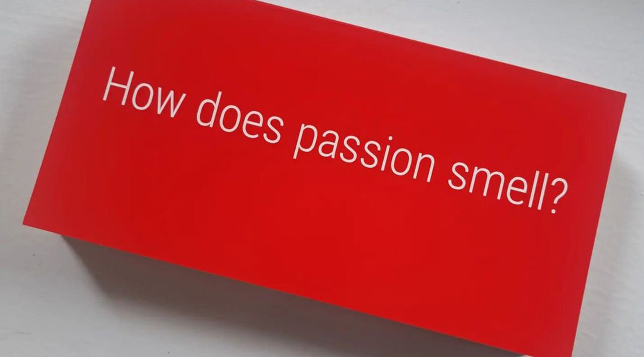 An Olfactory Art Keller exhibition featuring a red box with &#039;how does passion smell?&#039; in white text